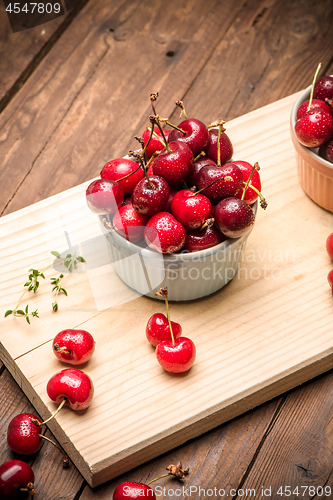 Image of Red ripe cherries in ceramic bowls