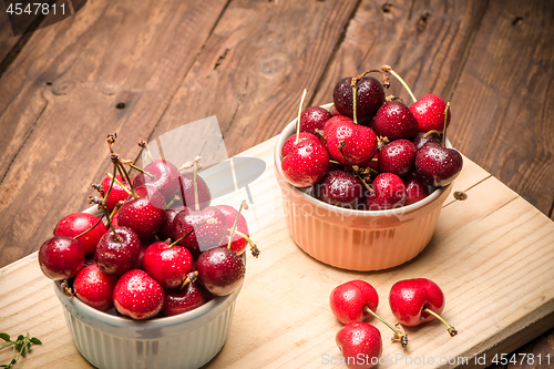 Image of Red ripe cherries in ceramic bowls