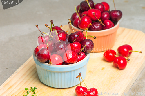 Image of Red ripe cherries in ceramic bowls