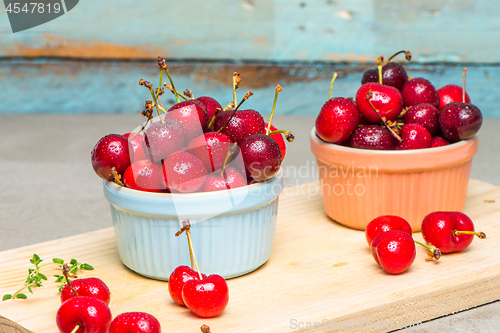 Image of Red ripe cherries in ceramic bowls