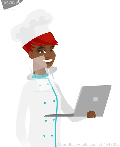 Image of Young african-american chef using a laptop.