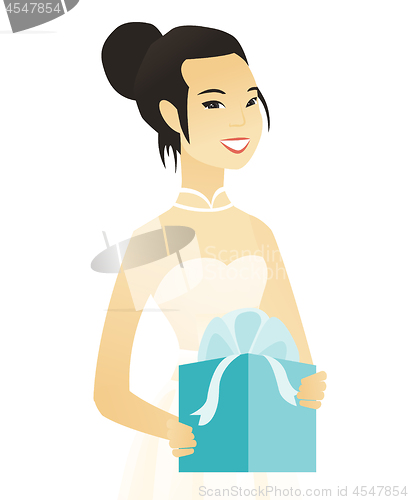 Image of Woman in a white bridal dress holding a gift box.