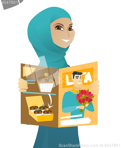 Image of Young muslim business woman reading magazine.