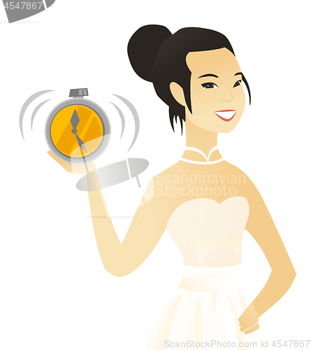 Image of Young asian fiancee holding an alarm clock.
