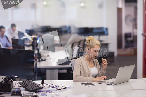 Image of businesswoman using a laptop in startup office