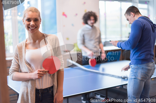 Image of startup business team playing ping pong tennis