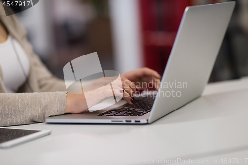 Image of businesswoman using a laptop in startup office