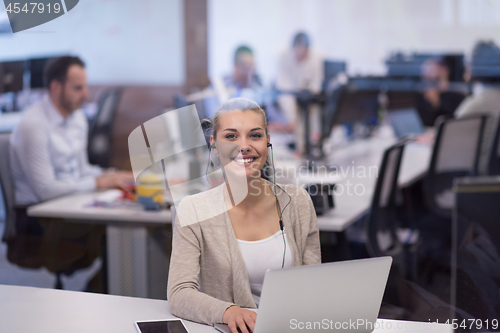Image of businesswoman using a laptop in startup office