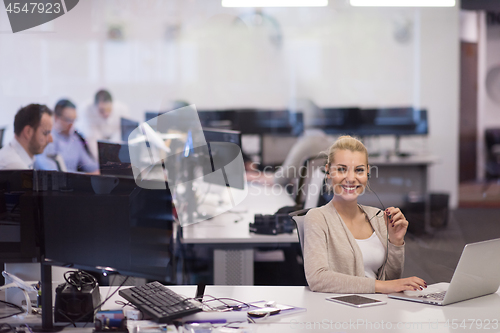 Image of businesswoman using a laptop in startup office