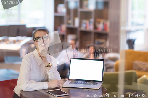 Image of businesswoman using a laptop in startup office