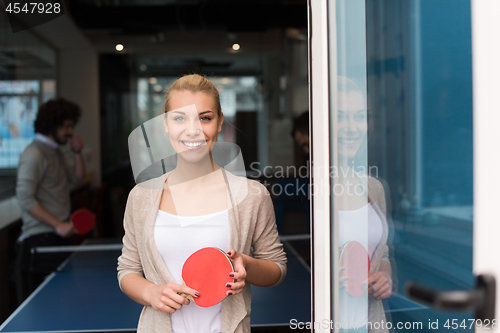 Image of startup business team playing ping pong tennis