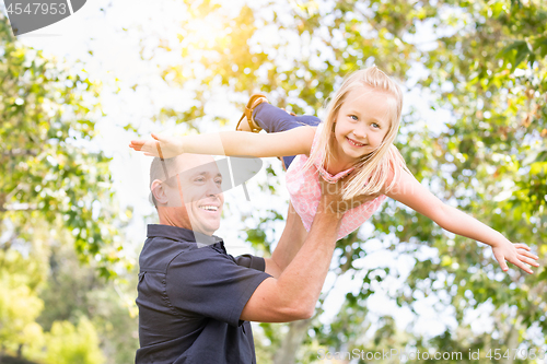 Image of Young Caucasian Father and Daughter Having Fun At The Park