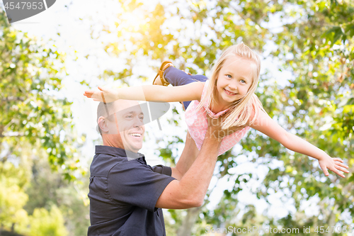 Image of Young Caucasian Father and Daughter Having Fun At The Park