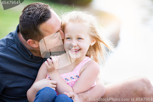 Image of Young Caucasian Father and Daughter Having Fun At The Park