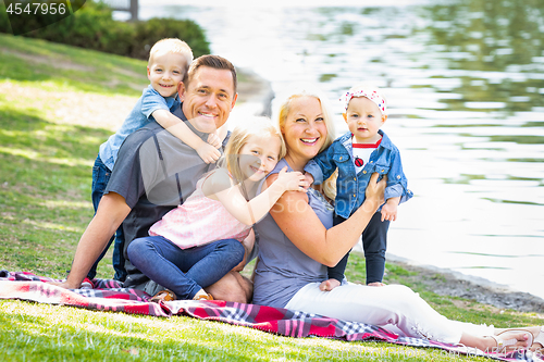 Image of Happy Young Caucasian Family Portrait In The Park