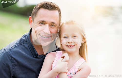 Image of Young Caucasian Father and Daughter Having Fun At The Park