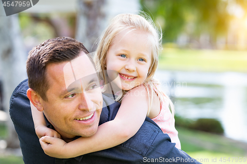 Image of Young Caucasian Father and Daughter Having Fun At The Park