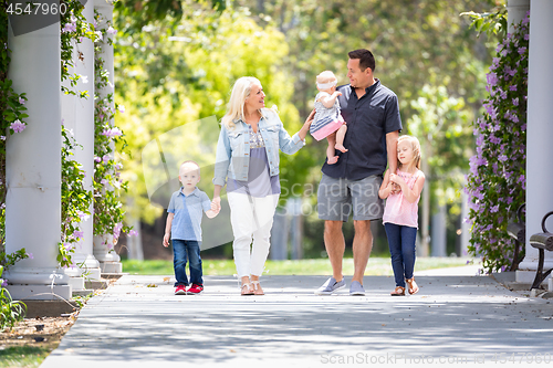 Image of Young Caucasian Family Taking A Walk In The Park