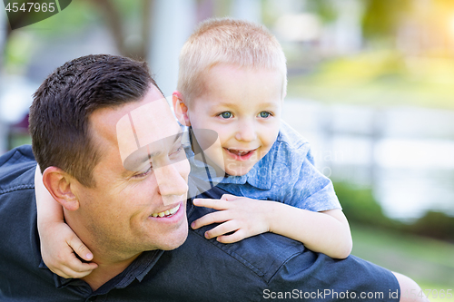 Image of Young Caucasian Father and Son Having Fun At The Park