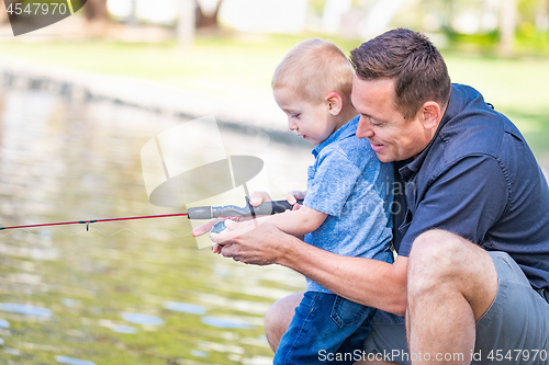 Image of Young Caucasian Father and Son Having Fun Fishing At The Lake