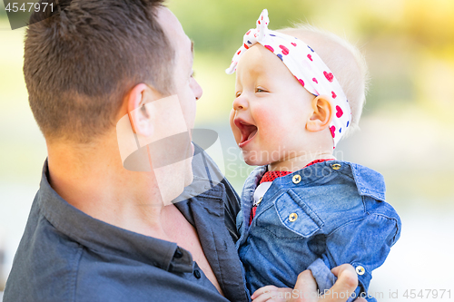 Image of Young Caucasian Father and Baby Girl At The Park