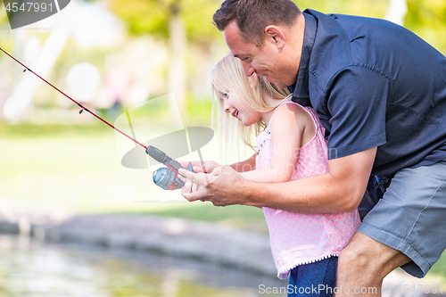 Image of Young Caucasian Father and Daughter Having Fun Fishing At The La