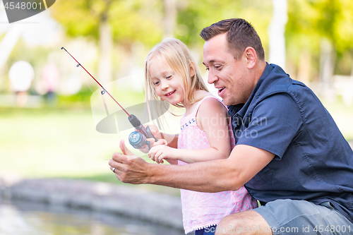 Image of Young Caucasian Father and Daughter Having Fun Fishing At The La