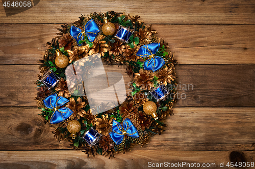 Image of Christmas wreath on wooden background