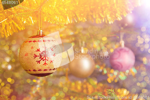 Image of Christmas-tree decoration bauble on decorated Christmas tree bac