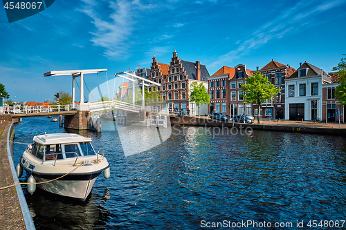 Image of Spaarne river with boat and Gravestenenbrug bridge in Haarlem, N