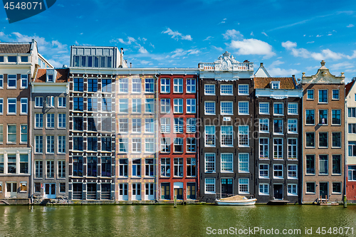 Image of  houses and boat on Amsterdam canal  Damrak with reflection. Ams