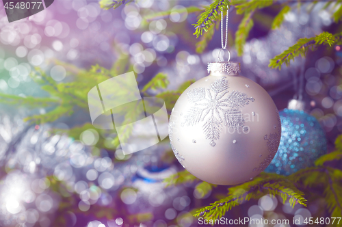 Image of Christmas-tree decoration bauble on decorated Christmas tree bac