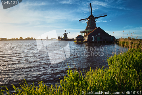 Image of Windmills at Zaanse Schans in Holland on sunset. Zaandam, Nether