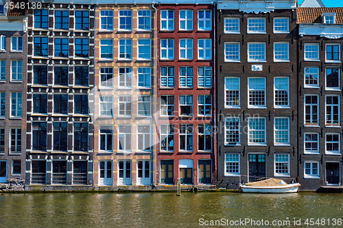 Image of  houses and boat on Amsterdam canal  Damrak with reflection. Ams