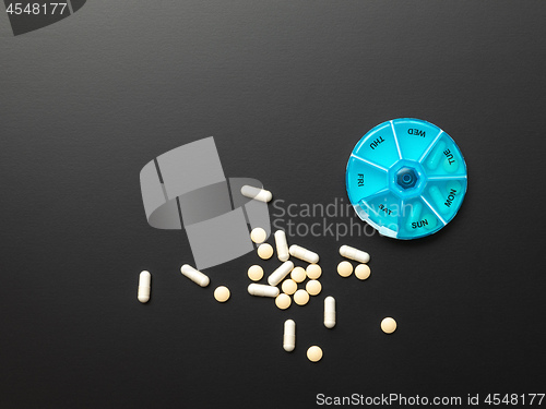 Image of open pillbox with some pills