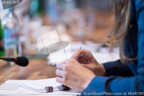 Image of close up of business people taking notes