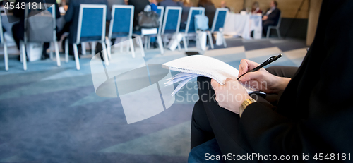 Image of close up of business people taking notes