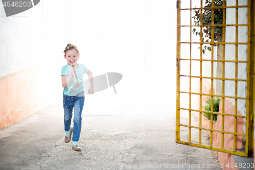 Image of little girl running on the city streets