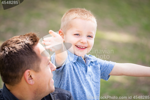 Image of Young Caucasian Father and Son Having Fun At The Park