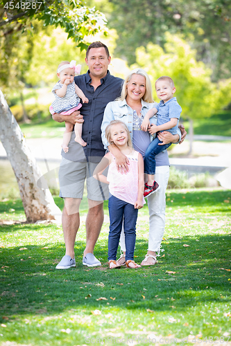 Image of Happy Young Caucasian Family Portrait In The Park