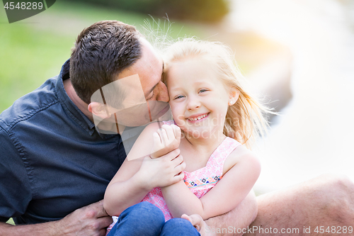 Image of Young Caucasian Father and Daughter Having Fun At The Park