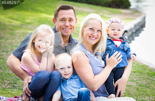 Image of Happy Young Caucasian Family Portrait In The Park