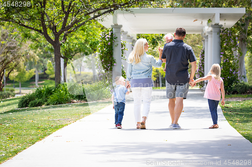 Image of Young Caucasian Family Taking A Walk In The Park