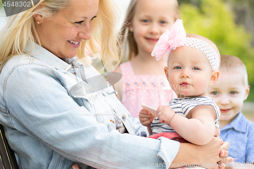 Image of Young Caucasian Mother and Children At The Park