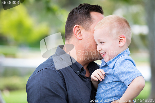 Image of Young Caucasian Father and Son Having Fun At The Park
