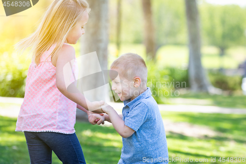 Image of Young Brother and Sister Playing At The Park Togther