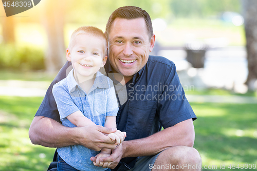 Image of Young Caucasian Father and Son Having Fun At The Park