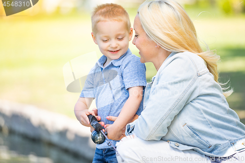 Image of Young Caucasian Mother and Son Having Fun Fishing At The Lake