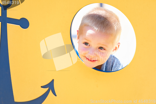 Image of Happy Young Boy Having Fun At The Playground