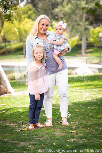 Image of Happy Young Caucasian Mommy and Daughters Portrait In The Park